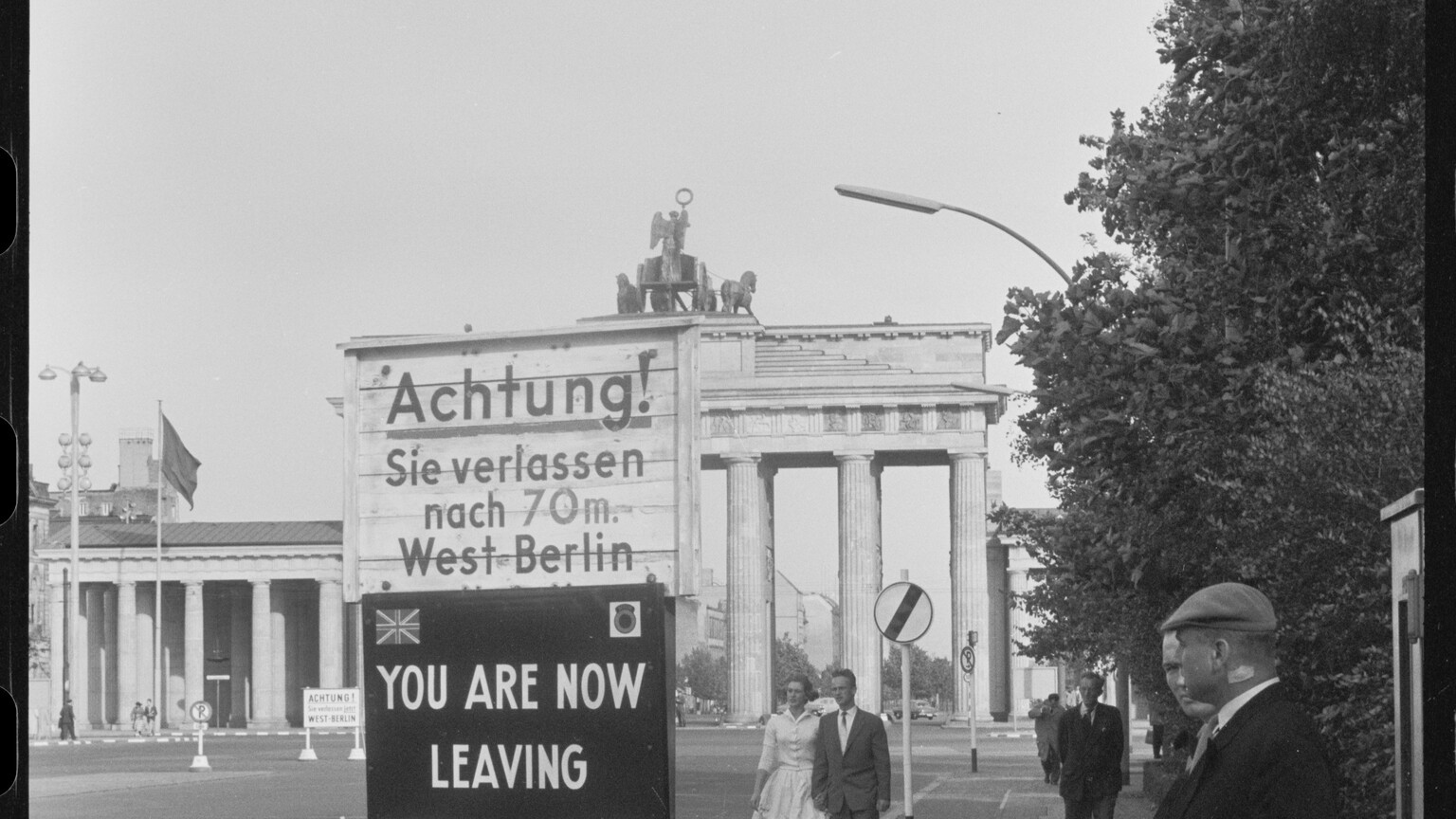 Historic photograph of the Brandenburg Gate in Berlin with Cold War border warning signs marking the British sector