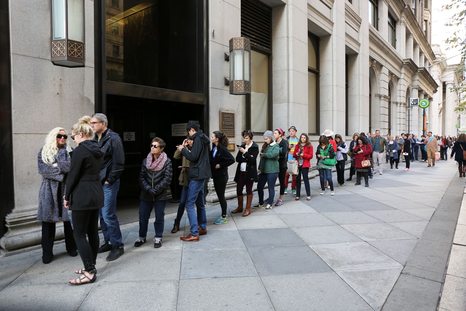 Voters wait in a long line along a city sidewalk to cast their ballots in Philadelphia on Election Day, November 8, 2016
