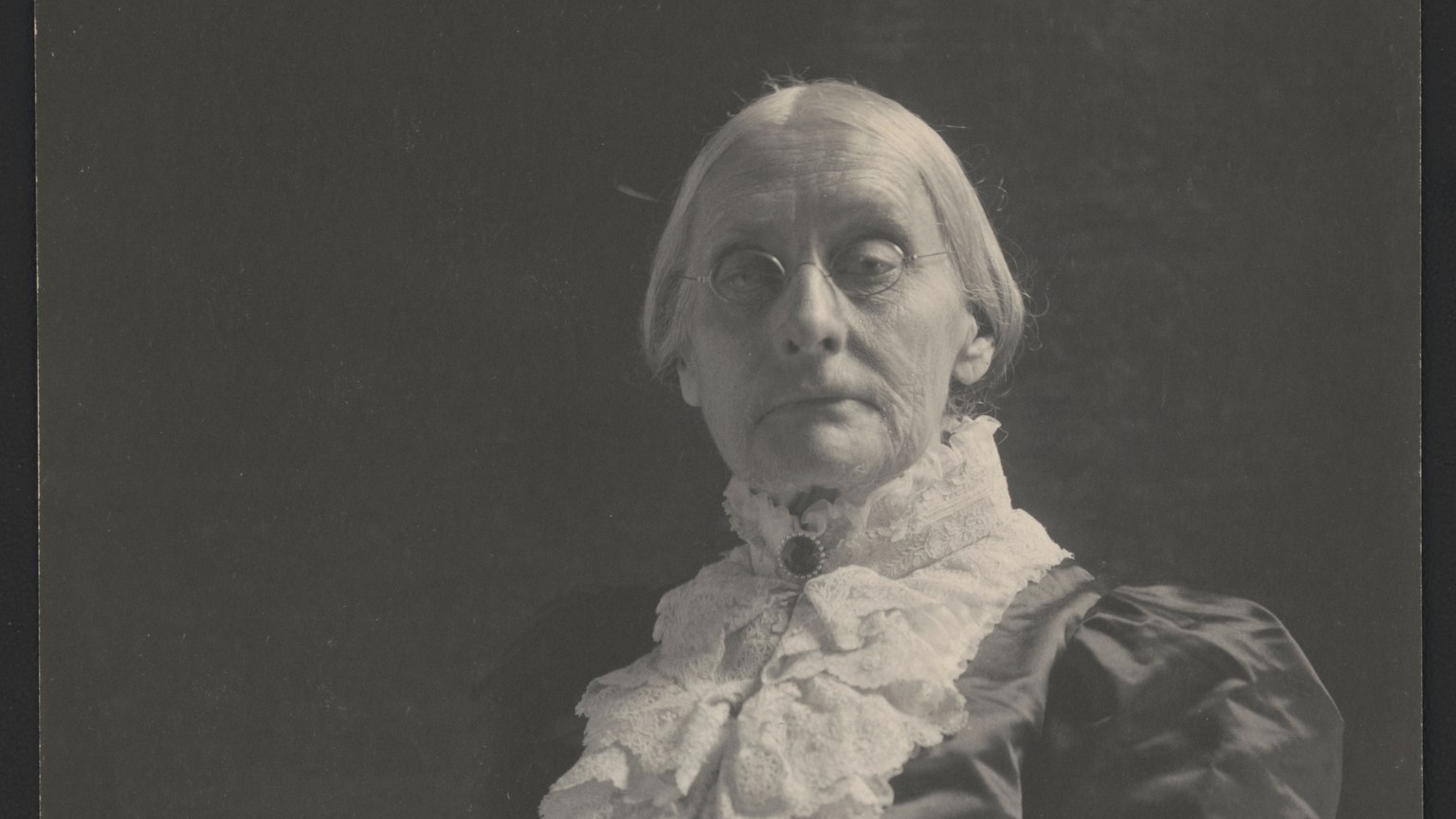 Historic studio portrait of Susan B. Anthony wearing spectacles and a lace collar