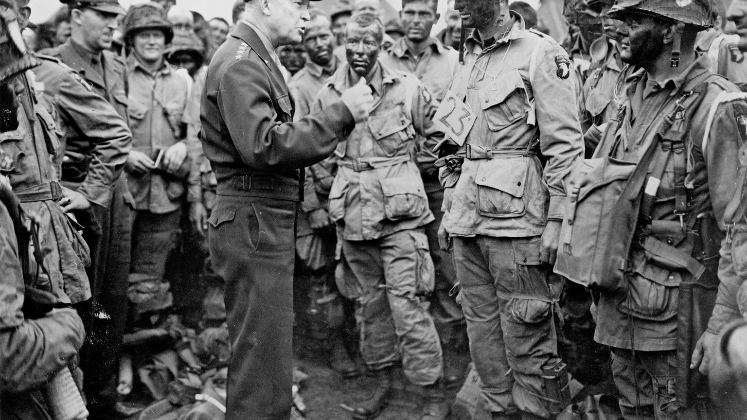 General Dwight D. Eisenhower speaking with U.S. Army paratroopers in combat gear on the eve of D-Day, June 1944